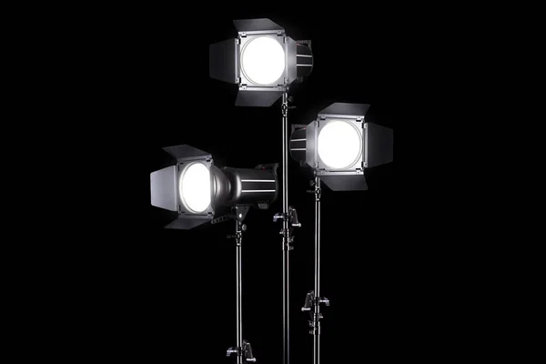 Photography studio flash on a lighting stand isolated on black background. — Stock Photo, Image