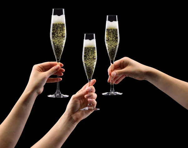Set of hands holding glass of sparkling champagne isolated on black. — Stock Photo, Image