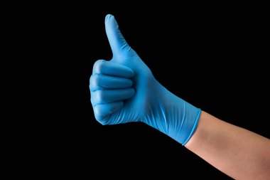 Doctors hand in medical gloves in gesture of like sign giving thumb up isolated clipart