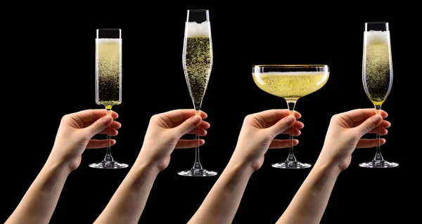 Set handen met glas champagne geïsoleerd op zwart. — Stockfoto