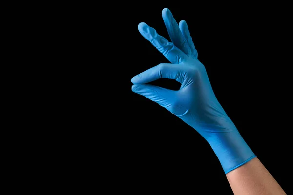 Doctors hand in medical gloves holding something with two fingers isolated — Stock Photo, Image