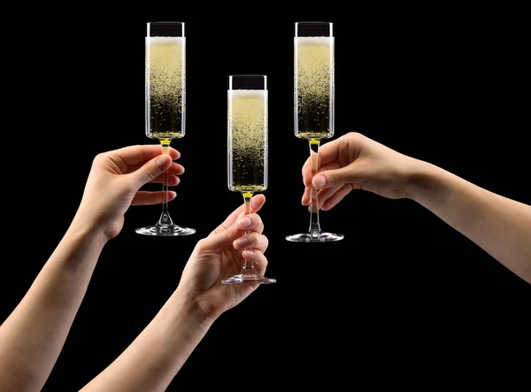 Set handen met glas champagne geïsoleerd op zwart. — Stockfoto