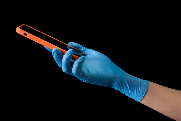 Doctors hand in medical gloves holding phone for safety payment isolated — Stock Photo, Image