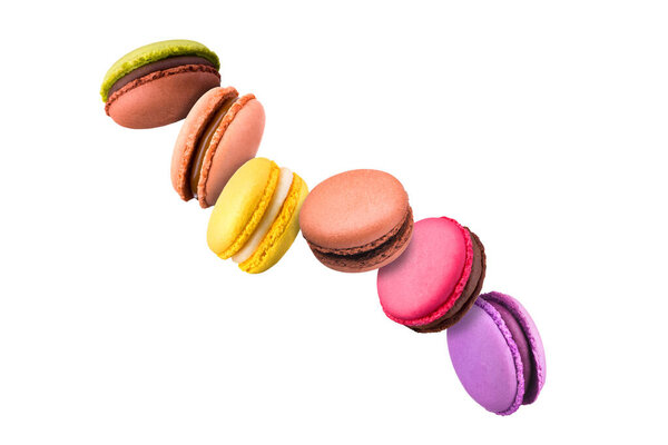 Set of flying french colorful macaroons isolated on white background.