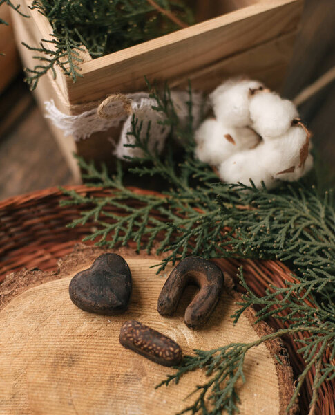 I love you spelled with letters and a heart made of chocolate candies on cross section of tree trunk