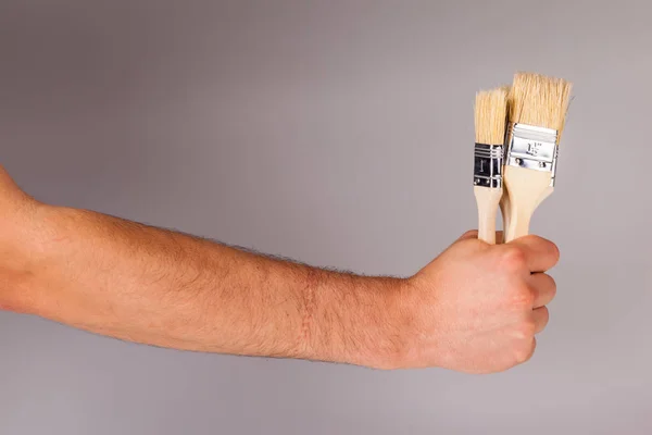 Holding some paintbrushes Stock Picture