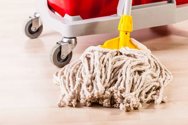 Cleaning wooden floor with mop — Stock Photo, Image