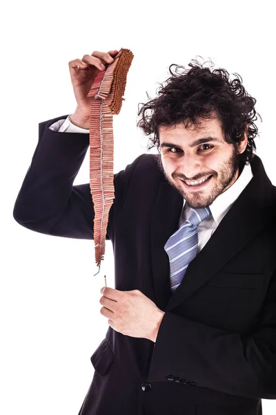 Smiling businessman lighting chained firecrackers — Stock Photo, Image