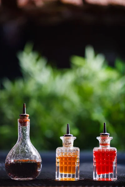 Three Vials Spicy Aromatic Oils Orange Red Flowers Stand Table — Stock Photo, Image