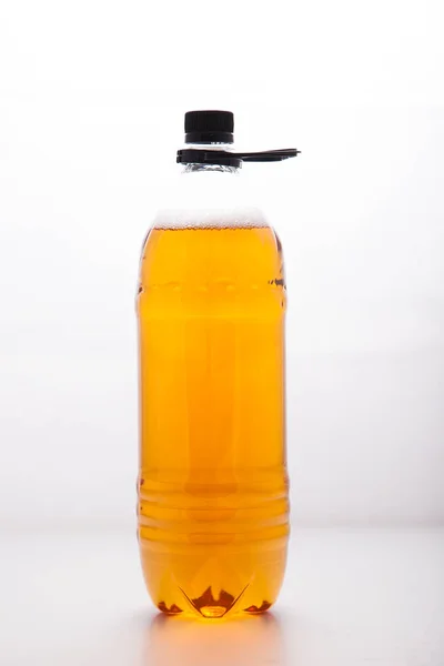 Plastic disposable transparent bottle with a light beer on a cle — Stock Photo, Image