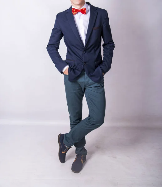 dark blue jacket red tie trousers man in studio