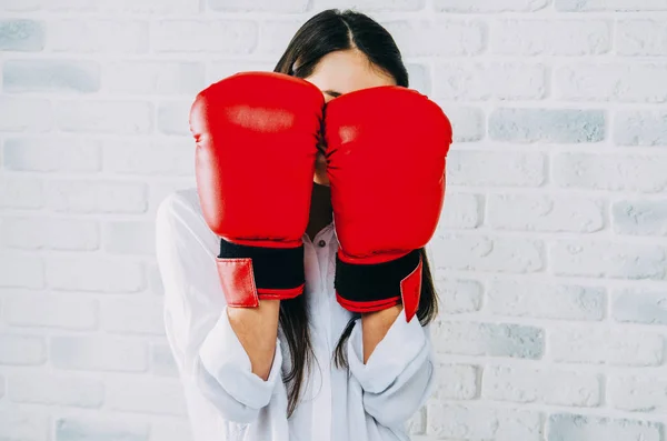 girl in red box gloves in white shirt and dark hair