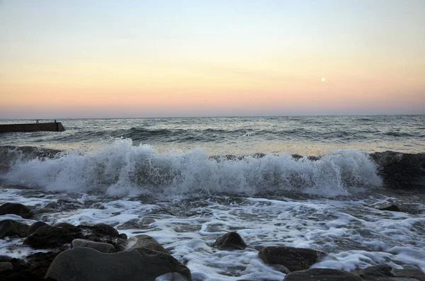 Sunrise on the sea with waves and stones — Stock Photo, Image