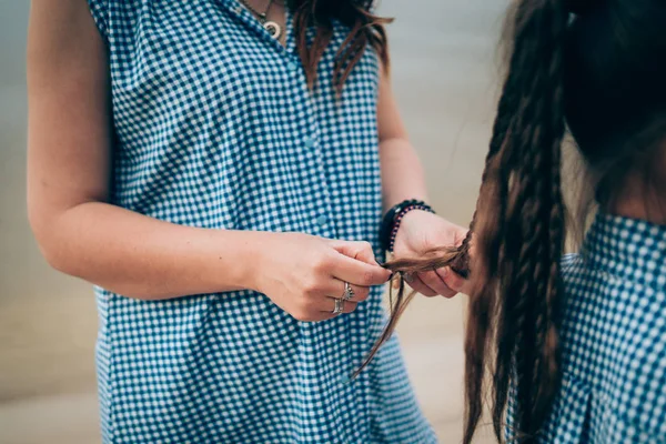 Braiding. Sisters are making of braids on head — Stock Photo, Image