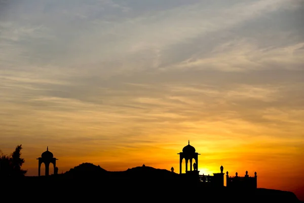 Silhouette of temple with sun