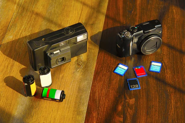 Film camera with camera rolls, digital camera with storage cards