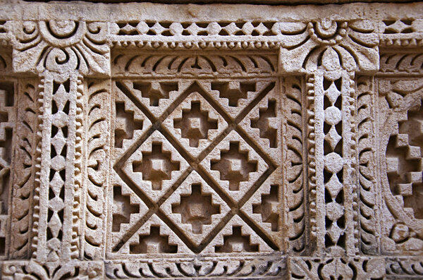 Carved Patola (Double Ikat) pattern on the inner wall of Rani ki vav, an intricately constructed stepwell on the banks of Saraswati River. Patan, Gujarat, India