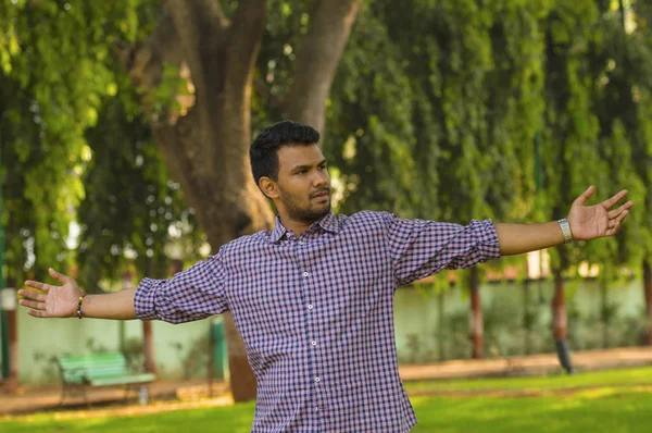 Guy spreading hands at park — Stock Photo, Image