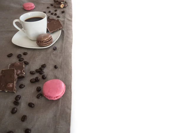Coffee cup, beans, chocolate and macaroons on old kitchen table with copyspace for your text — Stock Photo, Image