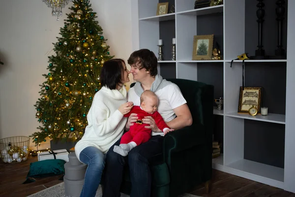 美しく装飾されたクリスマスツリー、クリスマスコンセプトの近くに家族のキス — ストック写真