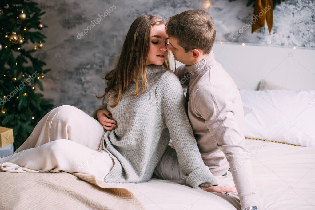 Romantic couple relaxing at home on Christmas time