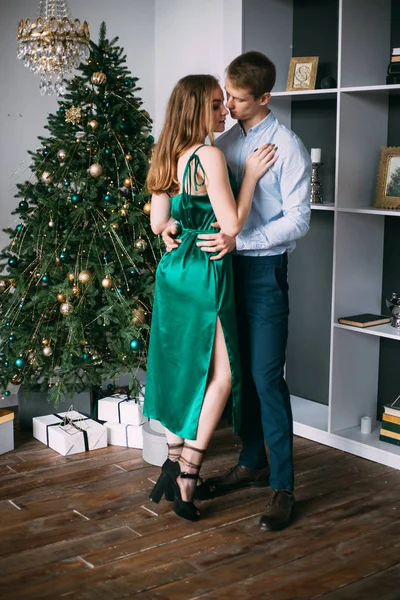 Glückliches Paar neben einem Weihnachtsbaum. Heiligabend. — Stockfoto