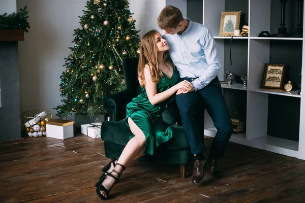 luxury fashion couple hugging near Christmas tree, New Year