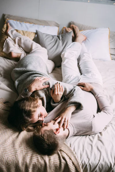 Beautiful loving couple hugging lying in bed — Stock Photo, Image