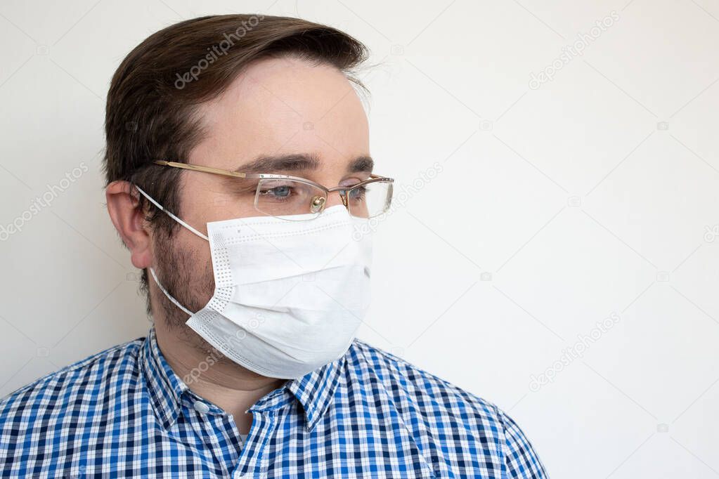 Man in hygienic mask to prevent infection, airborne respiratory illness such as flu, 2019-nCoV. Health safety concept COVID-19.