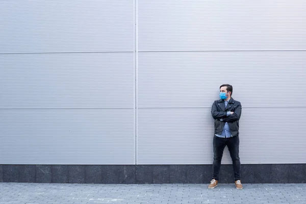 man wearing protective mask in the street. Sick man with flu wearing mask, epidemic flu concept on the street.