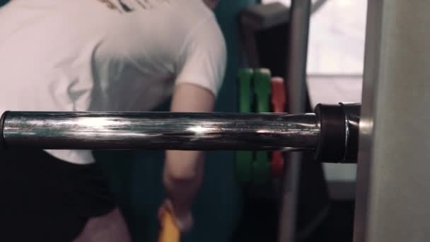 Brutal athletic man pumping up muscles on bench press — Stock Video