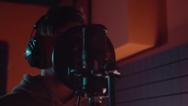Musik, bisnis pertunjukan, orang-orang dan konsep suara penyanyi laki-laki dengan headphone dan lagu nyanyian mikrofon di studio rekaman suara — Stok Video