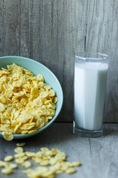 Flakes in a plate and a glass of milk — Stock Photo, Image