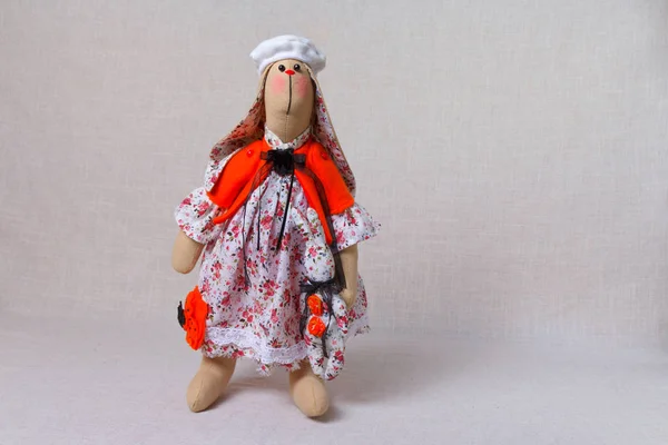 A toy rabbit in a French white dress with flowers and a beret on her head — Stock Photo, Image