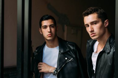 Güzel ve çekici bir adam şehirde poz veriyor. Siyah gözlüklerle şehirde dolaş. İletişim. arkadaşlarla buluş.