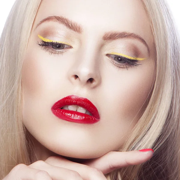 Portrait of woman with modern yellow eyeliner and red lips