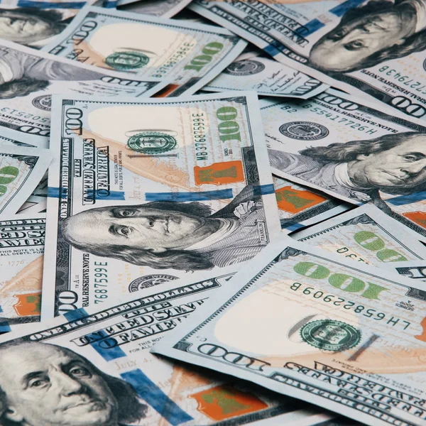 Cash of hundred dollar bills, dollar background image. A pile of one hundred US banknotes.