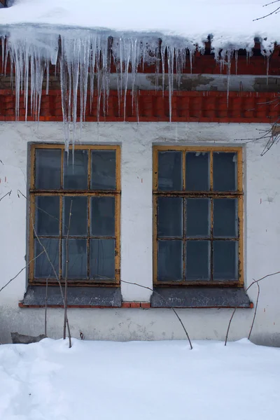 winter landscape and icicles in the old building