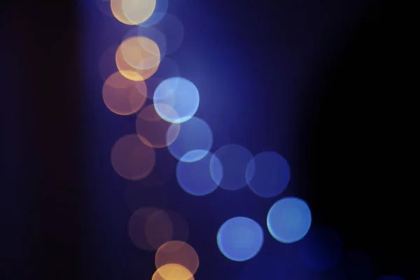 Defocused soft bokeh led Christmas lights trendy overlay in light blue and yellow color in the middle