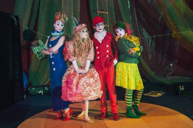 Moscow, Russia, May 16, 2015. Group of clowns on stage in the image. Theatrical clowning and Comedy make-up mass. The troupe of like-minded people was founded by Pavel Ivanov.