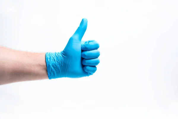 A mans hand in a blue rubber glove with a finger raised. — Stock Photo, Image