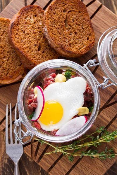 Tartare with quail egg and rye bread — Stock Photo, Image