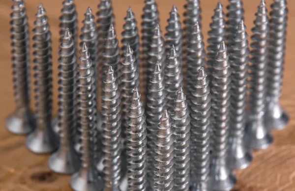 Universal silver screws with a triangle pointing upwards