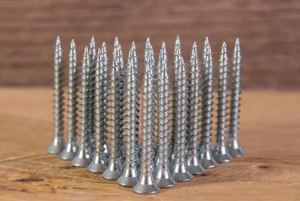 Universal silver screws with a triangle pointing upwards