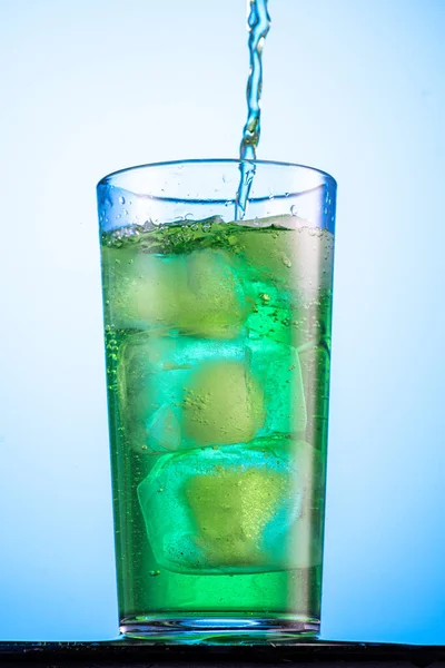 Geelgroene Koolzuurhoudende Limonade Een Glas Met Ijs Stroming Plons — Stockfoto