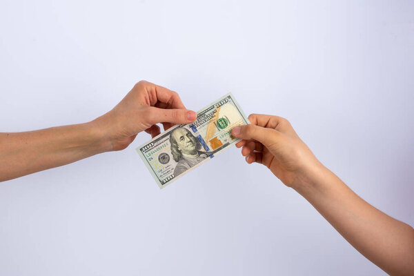 передача стодолларовой купюры в качестве оплаты за услуги или покупку
