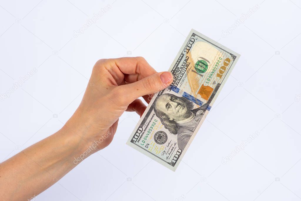 handing over a one hundred dollar bill, as payment for services or purchase