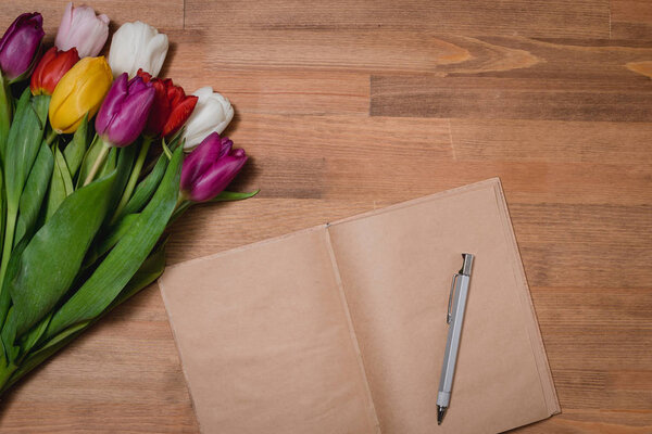 tulips notebook wooden table