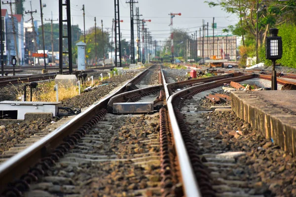 Branch of railroad for the train change route. Beside the rails are many poles and cable.