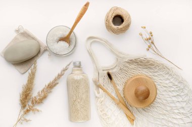 Body scrub, soap, string eco bag, beech toothbrushes, sea bath salt,body brush and other spa objects on light background